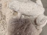 a statue of a frog that is sitting on top of a rock