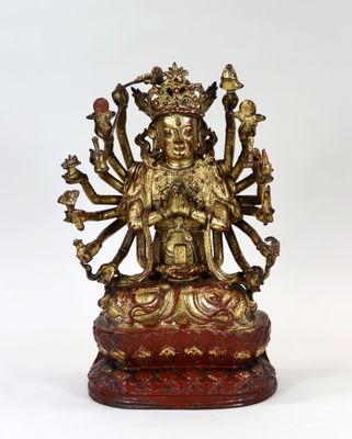 une image représentant une statue de Bouddha en or posée sur un socle rouge