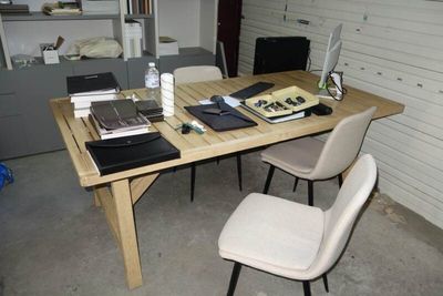 a wooden table with a laptop on top of it