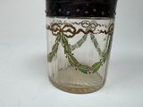 a glass jar with a black lid on a white table