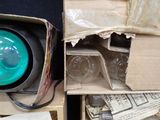 a green traffic light sitting on top of a cardboard box