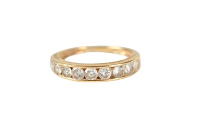a close up of a gold ring with diamonds on a white background