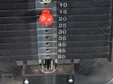 a close up of a machine with a red handle on it