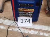 a blue portable air compressor sitting on the ground