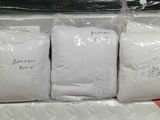 three bags of white pillows on top of each other