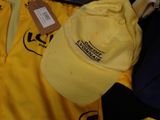 a yellow hat sitting on top of a pile of clothing