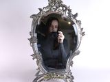 a woman taking a picture of herself in a mirror