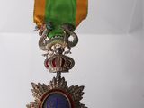 an image of a medal with a ribbon hanging from it ' s side