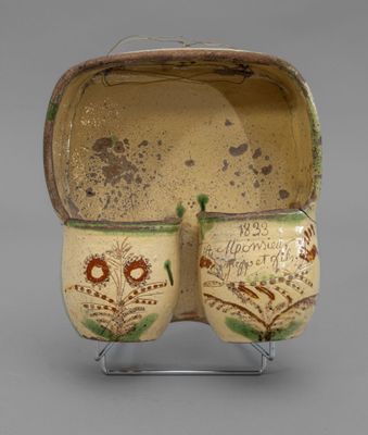pair of ceramic owl mugs on stand on grey background