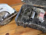 two circular saws in a box on a table