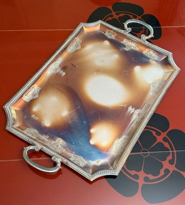 a picture of a silver tray on a red table