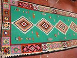 rug on the floor of a house with a green background