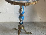 a small table with a blue and gold design on it