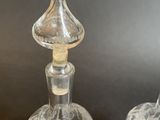 pair of antique cut glass decanters on a black background