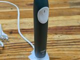 a bottle that is sitting on a table with a charger