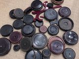 a pile of buttons on the floor next to a chair