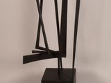 an image of a sculpture made of black metal on a white background