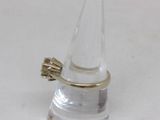a clear glass with a gold ring on top of it
