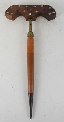 an old wooden tool with a wooden handle on a white surface