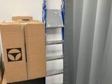 boxes are stacked on top of each other in a room with a ladder