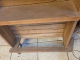 a wooden shelf with a clock on top of it