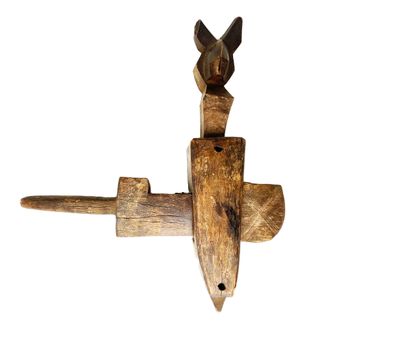 a wooden object with a bird on top of it
