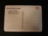 a white postcard with a picture of a porsche logo on it
