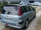 a silver car that is parked on the side of the road