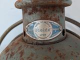 an old gas can with a metal lid and a sign on it