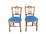pair of antique chairs with blue upholstered cushions