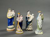 several figurines of different sizes and colors are displayed on a gray surface