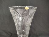 a clear glass vase with a yellow flower in it