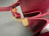 a red purse that is sitting on a table