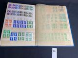 an open book with stamps on it sitting on a table