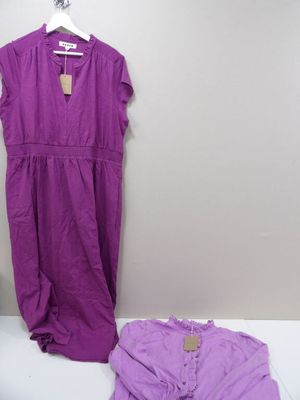 purple dress on a hanger next to a purple shirt on a white table