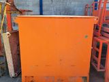 an orange cabinet sitting in the middle of a pile of chairs