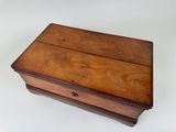 an old wooden box sitting on top of a white surface