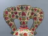 a vase that is sitting on a stand on a table