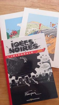 three books that are sitting on a wooden table