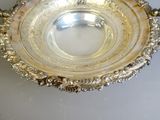 a silver plate with a handle on a table