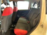 a small car with a red seat cover in the back of it