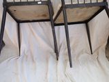 two chairs that are sitting next to each other on a bed