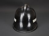 a close up of a black helmet with a white stripe on the side