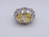 a yellow and white diamond ring on a white surface