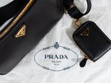 prada black leather handbag and wallet on a white background