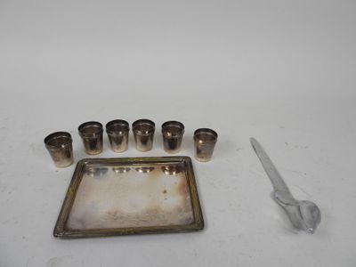 a silver tray with six glasses and a pair of scissors on it