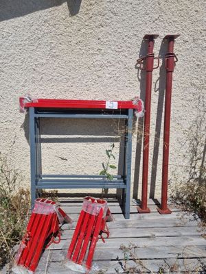 a red fire hydrant sitting next to a red fire hydrant on a wooden platform