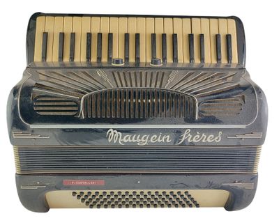 an old accordion with the words magnan perfect written on it