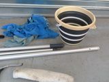 a bucket and a mop on the floor next to a bucket