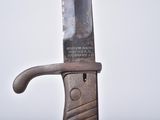a knife that is sitting on top of a piece of wood